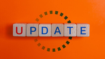 Wooden blocks with the words UPDATE and loading icons progress. Business concept for act updating something someone or updated version program.