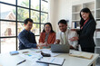 © crizzystudio - Business group joins together Young Asian businessmen to present and explain investment project reports and planning strategies. Budget calculation Business growth report on a company laptop.