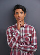 © M S/peopleimages.com - Portrait, serious and Indian person with designer and gray background at a creative agency office. Hipster, confidence and non binary employee with modern and casual clothing with fashion and style