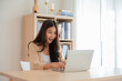 © Monster Ztudio - Happy euphoric young asian woman celebrating winning or getting ecommerce shopping offer on computer laptop. Excited happy girl winner looking at notebook celebrating success