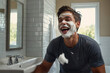 © руслан малыш - Happy man laughing in bathroom while shaving with foam on beard