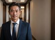 © kineter_ai - Portrait of a smiling Japanese business leader exuding expertise in a contemporary workspace