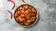 Spicy Indian Style Chilli Chicken Dry in Plate, Top View, Grey Concrete Background