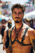 Sexy muscular latino gay man with bare abs in leather harness at the LGBT parade