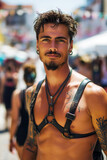 Fototapeta Tęcza - Sexy muscular latino gay man with bare abs in leather harness at the LGBT parade