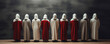 A group of mysterious figures in white and red hooded robes stand in a straight row, creating a captivating and intriguing scene. Banner. Copy space
