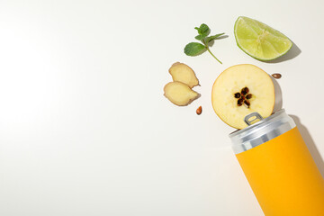 Sticker - Yellow tin can and lime, apple and ginger pieces on white background, space for text