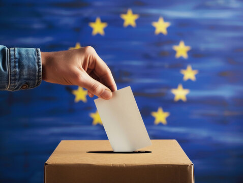 European Union elections concept image background , ballot box with EU flag colors and stars and hand holding a ballot paper voting 