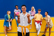 © Westend61 - Confident young man standing in front of group of friends showing middle fingers