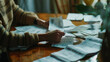 Person sorting through a multitude of bills and financial documents.