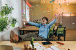 © Westend61 - Cheerful businessman throwing confetti at desk in office