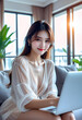 © anmitsu - A beautiful young female freelancer is sitting on a comfortable sofa and browsing the internet on her laptop to run a successful business. Luxurious interior. Work from home concept.