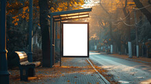 An Empty Bus Stop Advertisement Billboard Stands In An Autumnal Urban Setting With Fallen Leaves, A Bench, And Trees Lining The Street, Bathed In Warm Sunrise Or Sunset Light.