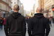 Back view of two skinhead neo-nazis with shaved heads in street. 