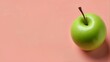 A crisp, bright green apple stands out against a soft, pastel pink background, creating a minimalistic feel