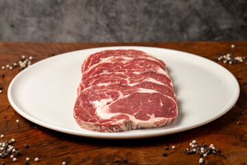 Wall Mural - Raw beef ribeye meat. Butcher products. Fresh beef ribeye meat on dark background