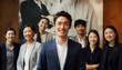 © BrightSpace - A Asian group of people are smiling for a photo. The man in the center is wearing a suit and smiling. The group is posing for a picture, and they all look happy
