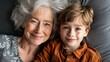 © AdriFerrer - Grandmother and grandson smiling, genuine family moment.