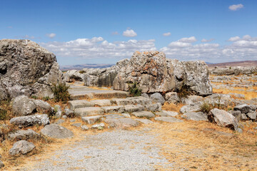 Wall Mural - Bronze Age city Hattusa, ancient hittites capital. Steps at the street to Great temple, archeological site of 6th millennium BC settlement. Bogazkale, Corum, Turkiye (Turkey)