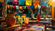 Cinco De Mayo With Colorful Margaritas On A Vibrant Tablecloth, Complete With Salt-rimmed Glasses And Lime Garnishes, Beer Bottles, And Traditional Papel Picado Banners In The Background