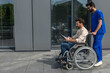 Male nurse taking a disabled patient on a wheelchair for a walk