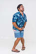 © Mdv Edwards - Middle-aged man in summer clothes showing signs of urgency and discomfort as he holds his bladder trying not to urinate into his shorts. Isolated on white.