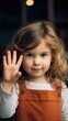 A young child waving goodbye. Fictional character created by Generated AI. 