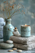 Couple of blue vases placed on towels, spa massage products, wellness
