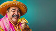 portrait of Cheerful Mexican Man in Vibrant Costume Enjoying a Flavorful Taco on Teal Background looking at camera