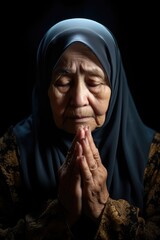 A woman in a headscarf praying with clasped hands.. Fictional character created by Generated AI. 