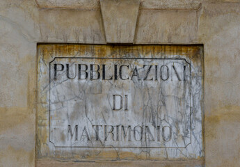 Wall Mural - Close-up of a marble sign worn out by time that says: 