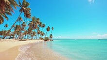 Beautiful Tropical Philippine Beach With Yellow Sand And Palm Trees. Turquoise Ocean Against A Blue Sky With Clouds On A Sunny Summer Day. The Ideal Landscape Backdrop For A Relaxing Holiday.