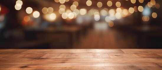 Wall Mural - A beautiful brown hardwood plank table with wood stain and varnish, set against a blurry background of amber lights. The flooring adds to the warm tints and shades of the scene