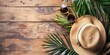summer tropical vacation background with palm leaf, beach hat, sunglasses and wooden wallpaper