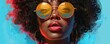 Portrait of a black woman wearing sunglasses.