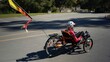 © Robert Peak - Elderly senior woman riding recumbent tricycle e-bike on a path on a sunny day in a park.