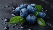 Juicy blueberries with vibrant green leaves and water drops.
