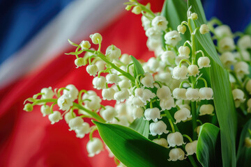 Wall Mural - Flowering lily of the valley on a street of Paris, with the French flag in the background. French tradition to offer lily of the valley on the 1st of May, which is a public holiday in France