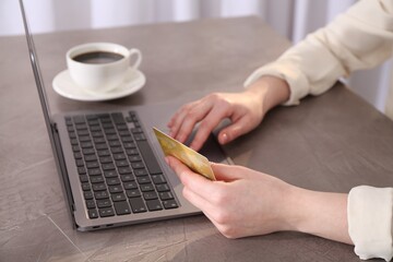 Canvas Print - Online payment. Woman with laptop and credit card at grey table, closeup