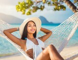 Fototapeta Młodzieżowe - Happy traveler asian woman with white bikini relax in hammock on beach
