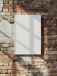 empty blank 3:4 aspect ratio canvas mockup hanging on a brick wall
