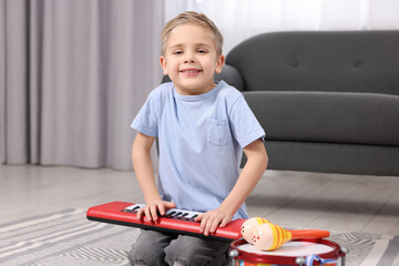 Poster - Little boy playing toy piano at home