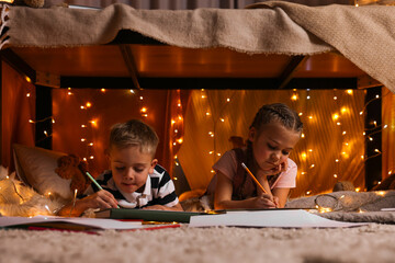 Canvas Print - Children drawing in play tent at home