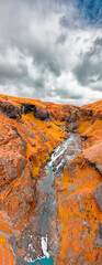 Wall Mural - Aerial view of beautiful Stjornafoss waterfall on a wet rainy day