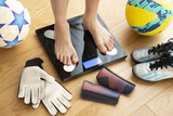 Fototapeta  - Kid or child feet on a weight scale concept suggesting being active