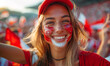 Portrait of a passionate female Polish fan celebrating at a UEFA EURO 2024 football match, her face painted with the colors and patterns of the Polish flag, radiating enthusiasm and national pride