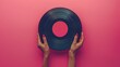 Poster. Contemporary art collage. Modern creative artwork. Female hand holding vintage disk for recording in old paper style isolated pink background. Concept of youth culture, retro, technology.