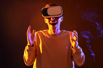 Poster - Young man with virtual reality headset on brown background