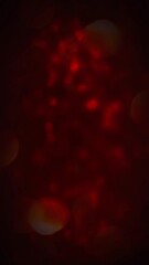 Wall Mural - vertical red bokeh lights dark atmosphere 4k loop features a dark red atmosphere with small circular