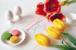 preparing a festive breakfast for mother's day with french macarons, eggs postcard, flowers and gifts, happy mother's day